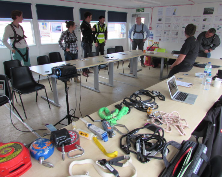 Height safety PPE Inspection training course. 7 trainees learning how to wear and inspect height safety equipment correctly.