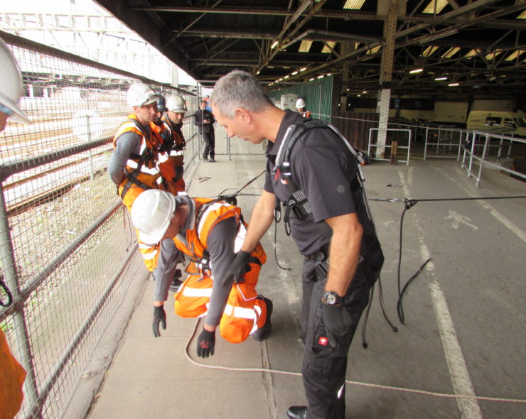 Trainee demonstrating fall arrest wearing fall protection kit