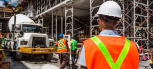 scaffolding on construction site with truck and workers